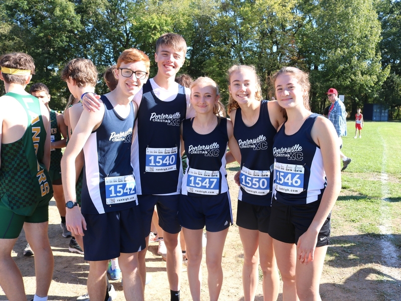 Girl in classroom raising hand